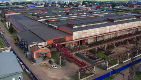 aerial view of expansive industrial complex with warehouses and railway