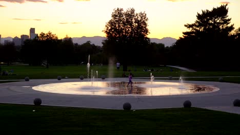 water fountain against a background of denver skyline