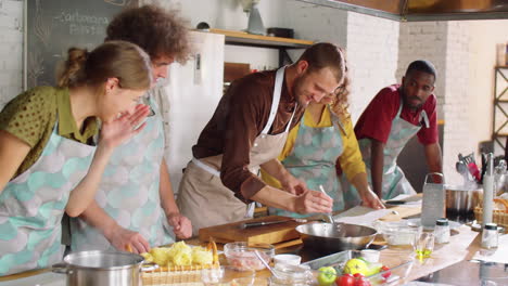 chef frying bacon during cooking master class