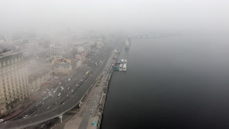 foggy cityscape with river and traffic