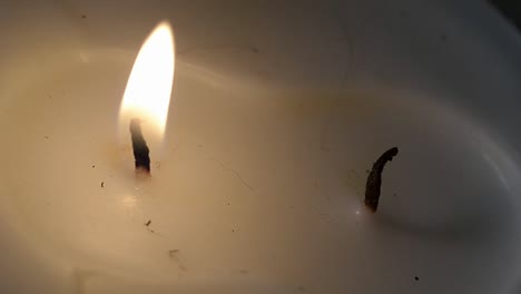 white candle burning one flame