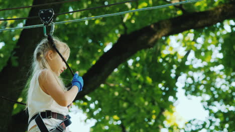 a brave child walks along a tightrope between tall trees active childhood and fun