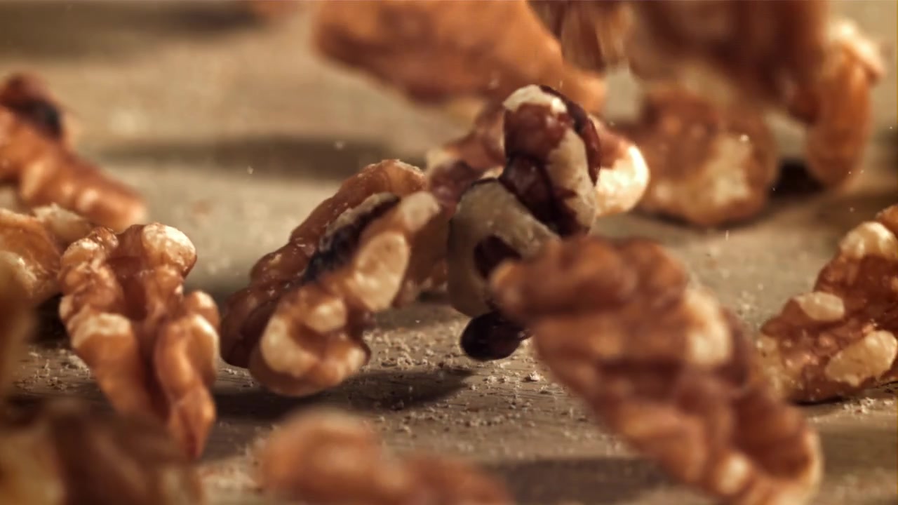 Walnuts Falling and Bouncing on a Wooden Surface in Slow Motion