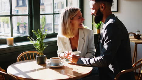 couple enjoying coffee and conversation in a cafe