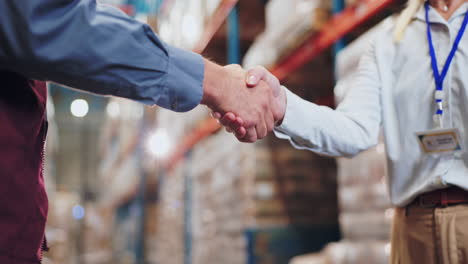 handshake between colleagues in a warehouse