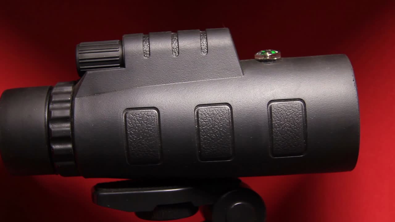 Close Up of Giant Mobile Phone Optical Zoom Lens Telescope Monocular in Red Background