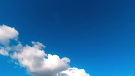 time lapse of white cumulus clouds moving against blue sky