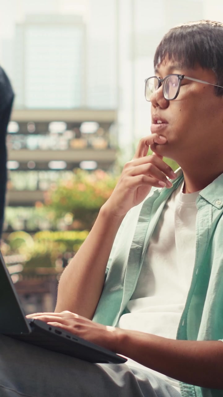 Vertical Video Pensive student pauses taking notes and thinking about ideas