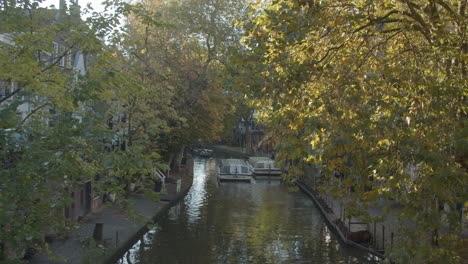 Tour-boat-driving-over-beautiful-canal-in-Utrecht-city,-the-Netherlands