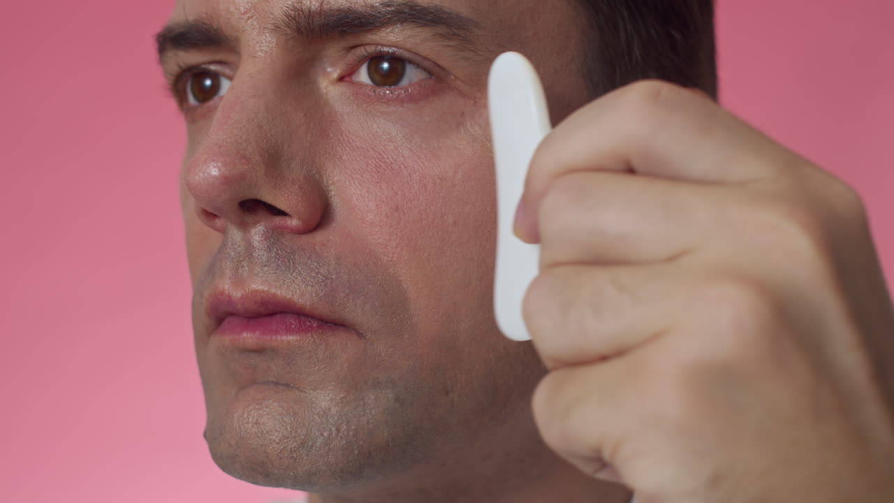 Face of Millennial Doing Anti-age Massage with Gua Sha Tool