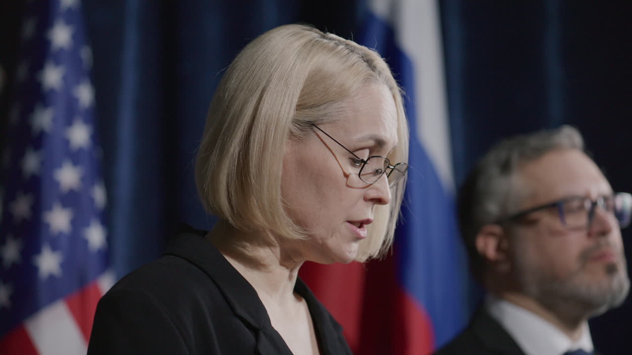 Female Politician Addressing Audience at International Press Event
