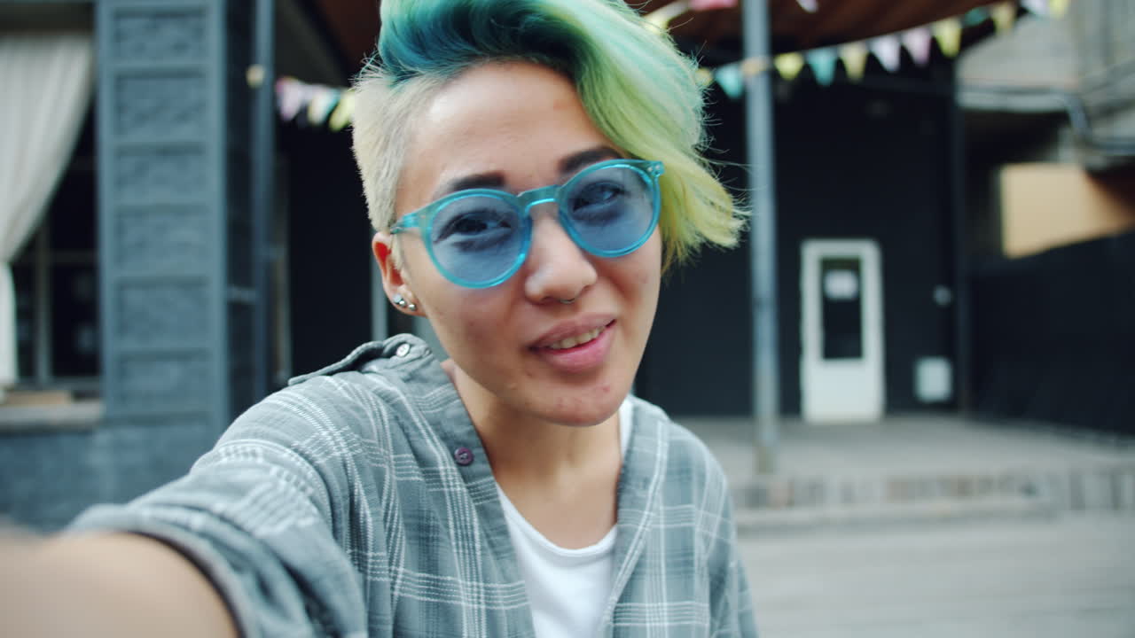 Smiling woman taking a selfie outdoors
