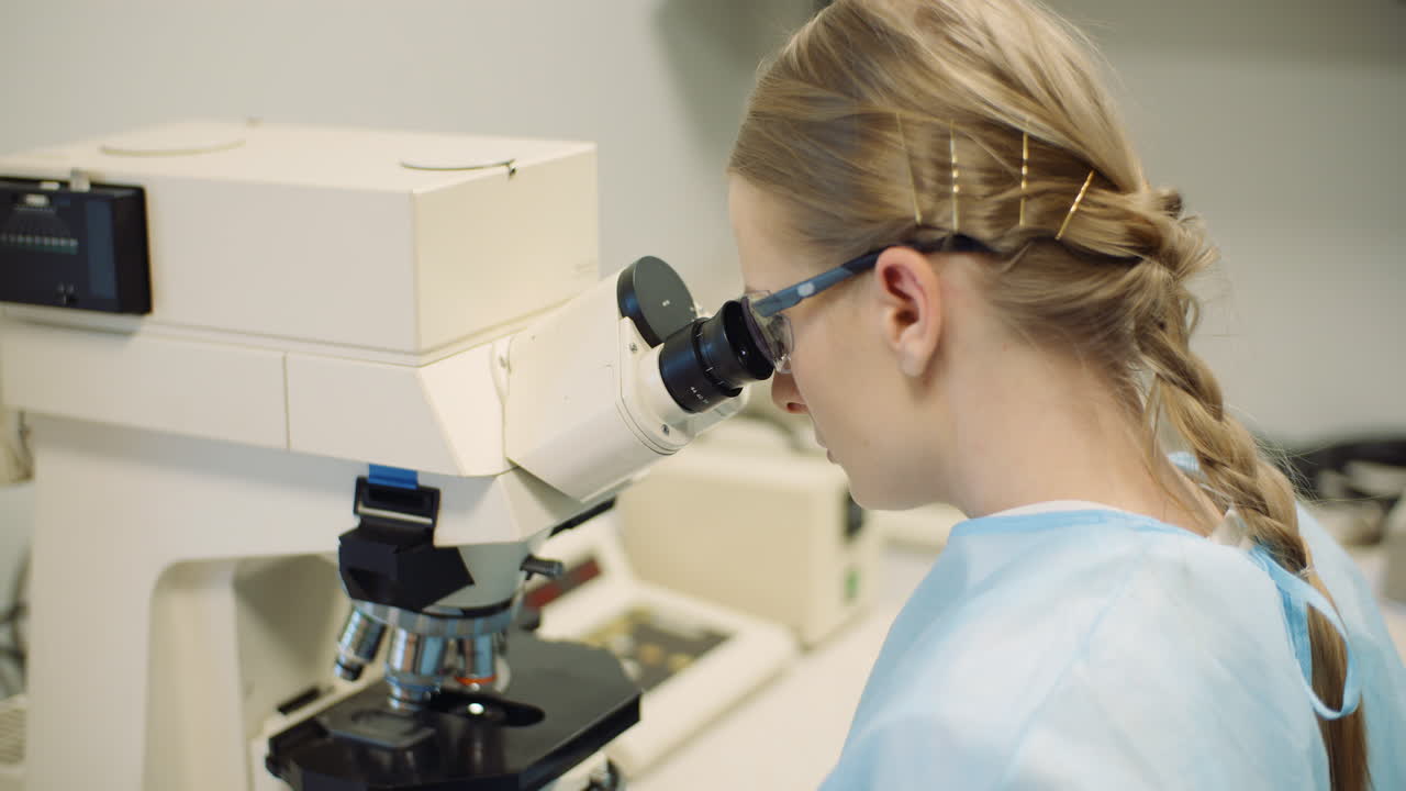 Scientist Examining Bacteria Under Microscope At Laboratory 1