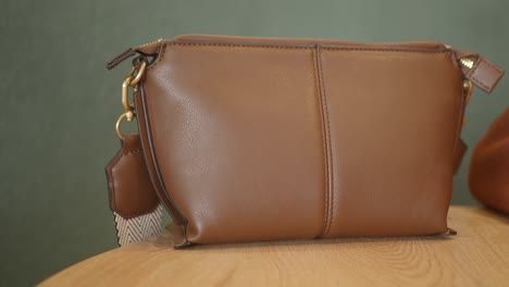 brown leather shoulder bag with gold hardware