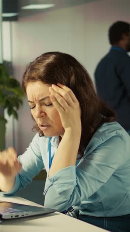 vertical video accountant in busy modern startup agency imputing financial figures on pc