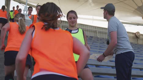 female hockey players warming up in stands