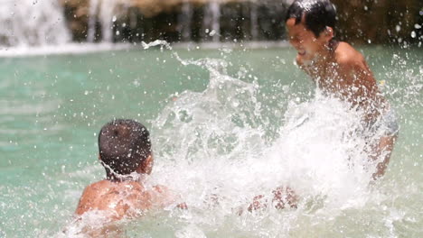 kids playing in a waterfall