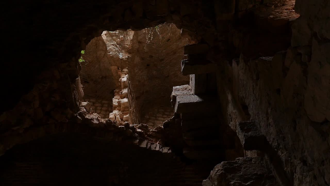View of the interior of the ruins of Otiñar Castle, showing stone walls, remains of arches and emptiness
