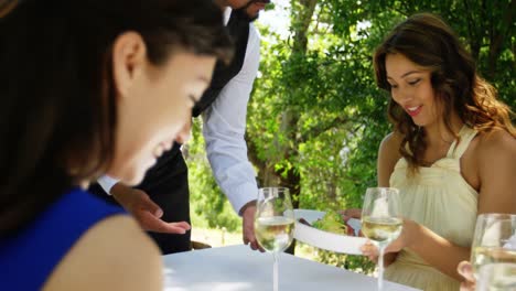 waiter serving food to couples