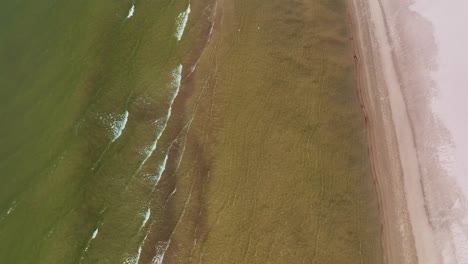 Aerial-view-Small-sea-waves-wash-the-beach