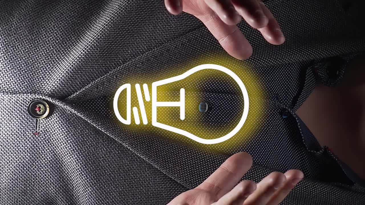 Idea lamp icon hologram appears on person chest wearing suit, close up view