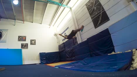 a-slow-motion-still-shot-of-a-guy-doing-flips-from-the-trampoline-landing-and-winning-having-fun-and-working-out-in-60fps