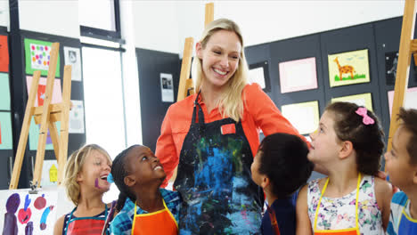 teacher and schoolkid having fun in drawing class