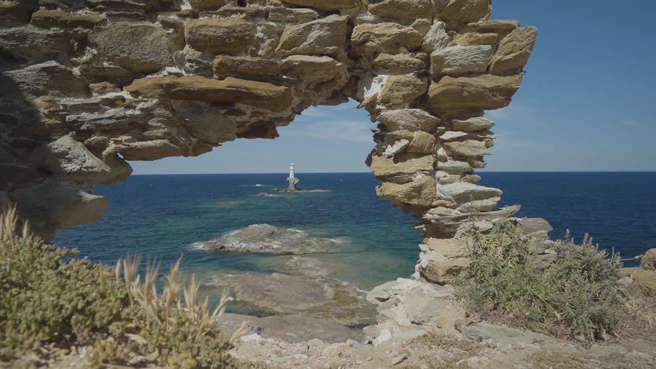 Dolly Shot of Tourlitis Lighthouse in Chora of Andros Among Medieval Ruins, Greece