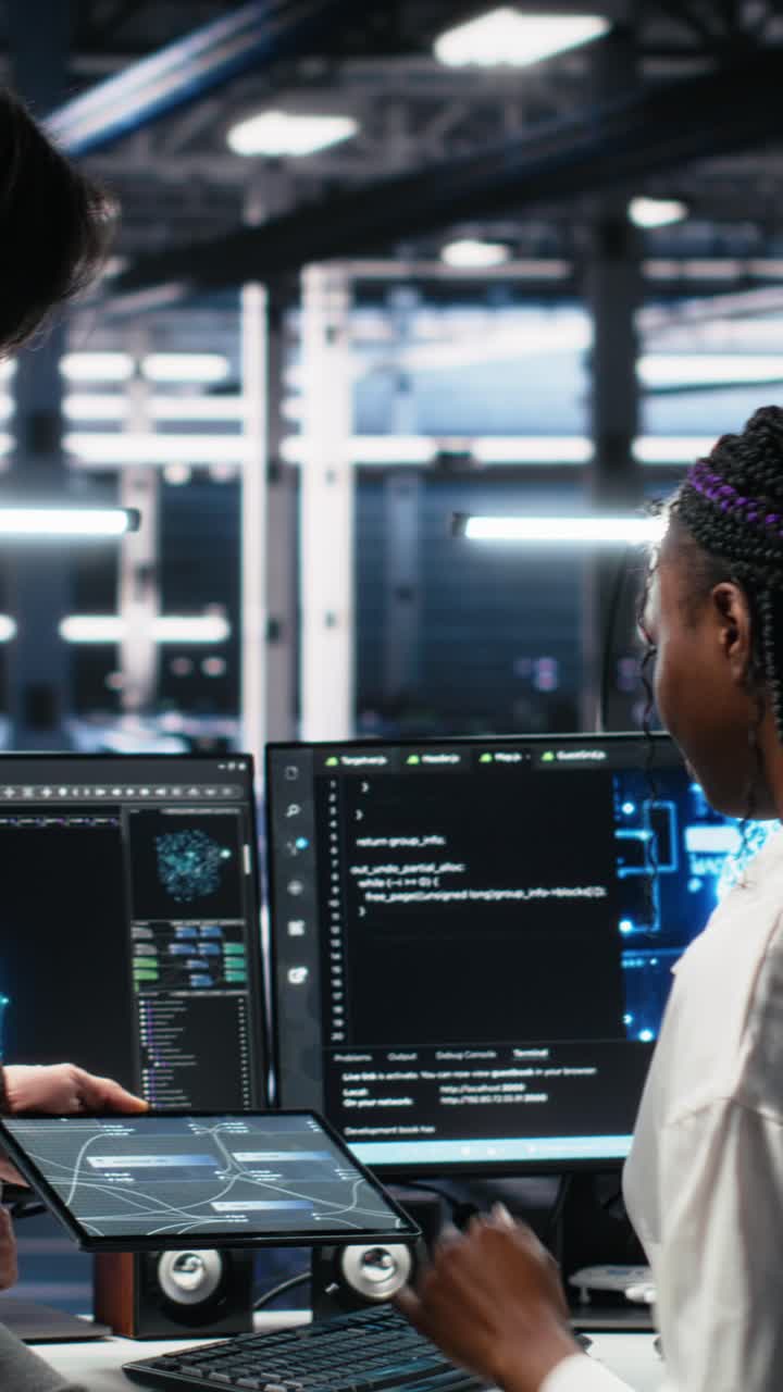 Vertical video Multiethnic team in diverse data center coding with generative AI assistance