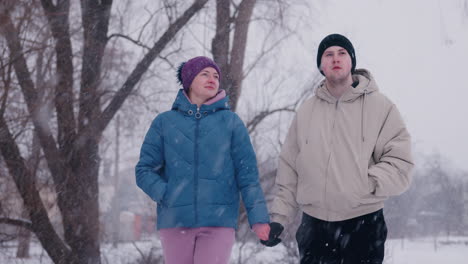 couple walking in snowy park