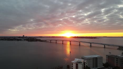 bay area of sarasota, florida during sunset. drone footage of golden gate point and the ringling bridge with the sunset in the background. shot in 24 fps.