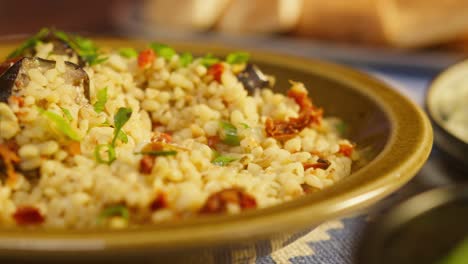 eating greenery on bulgur with eggplant close-up. traditional middle eastern culture. delicious rice with meat. arabian cuisine. homemade food concept