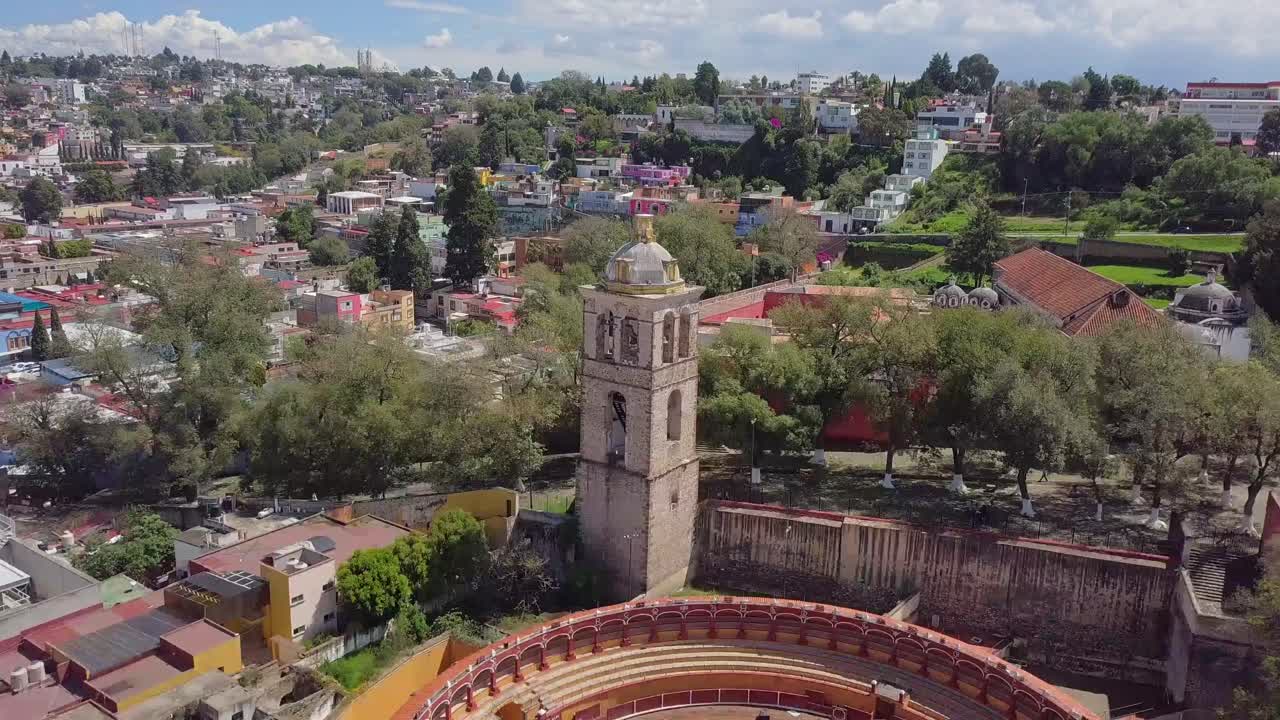 Drone footage of the historic bullring Plaza de Toros Jorge Aguilar in Tlaxcala, Mexico. Aerial view of the circular structure and surrounding streets