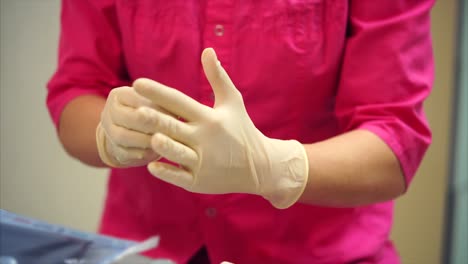 nurse putting on gloves