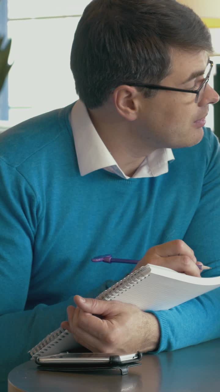 Man writing in notepad