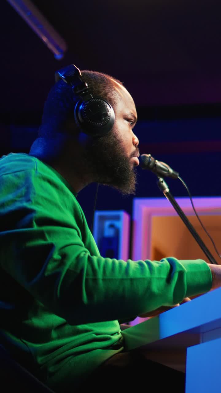 African American Man Playing Keyboard and Singing in Music Studio