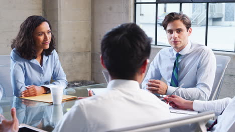 Young-businessman-holds-a-meeting-in-a-modern-office,-close-up