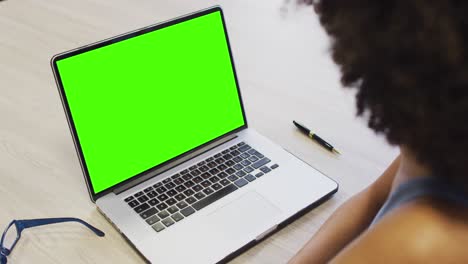 african american businesswoman using laptop for video call with copy space