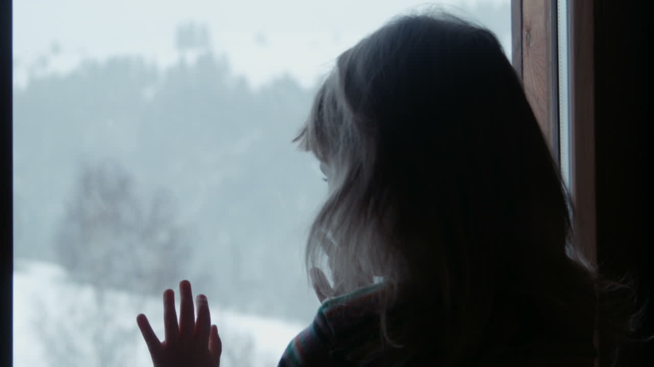 Little Cute Girl Behind Window In Winter (Stock Footage)