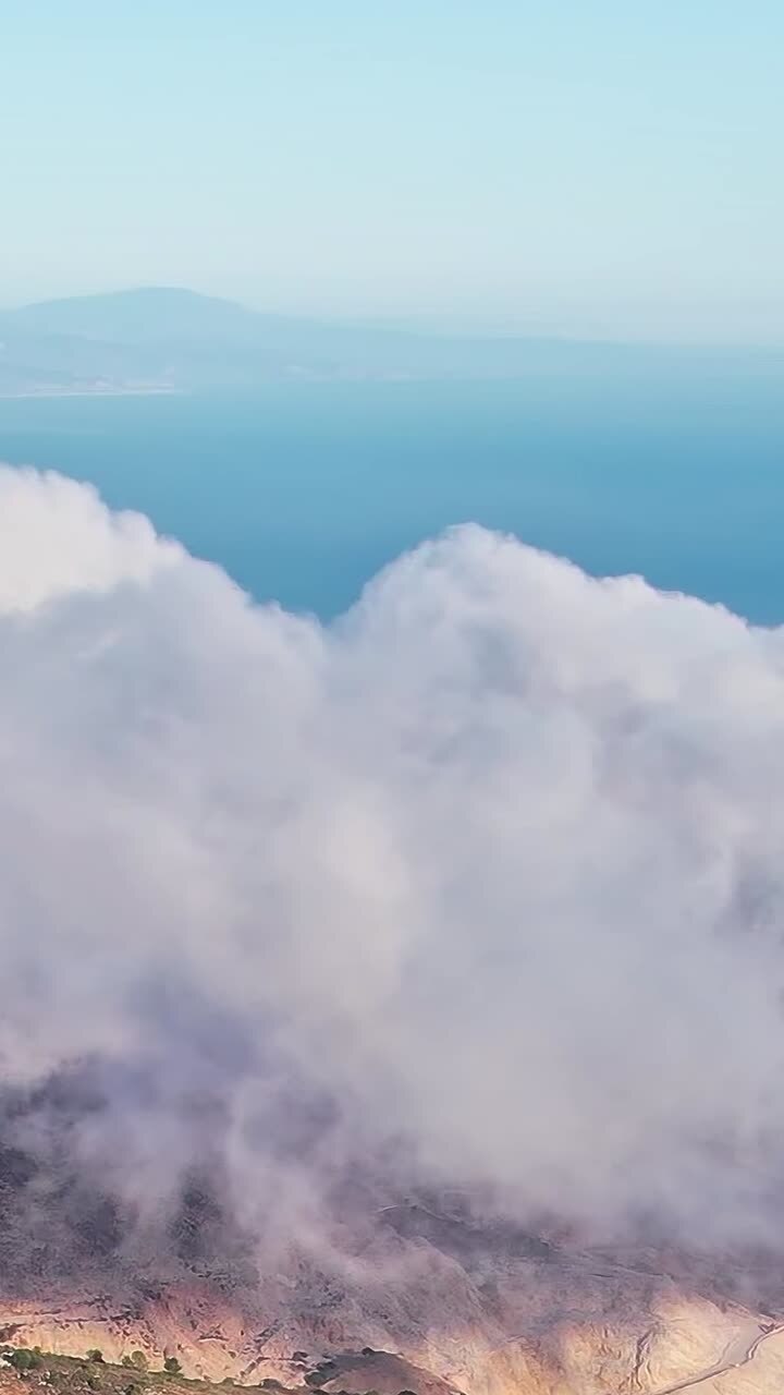 Clouds cover mountains near Malaga Spain during a sunny day