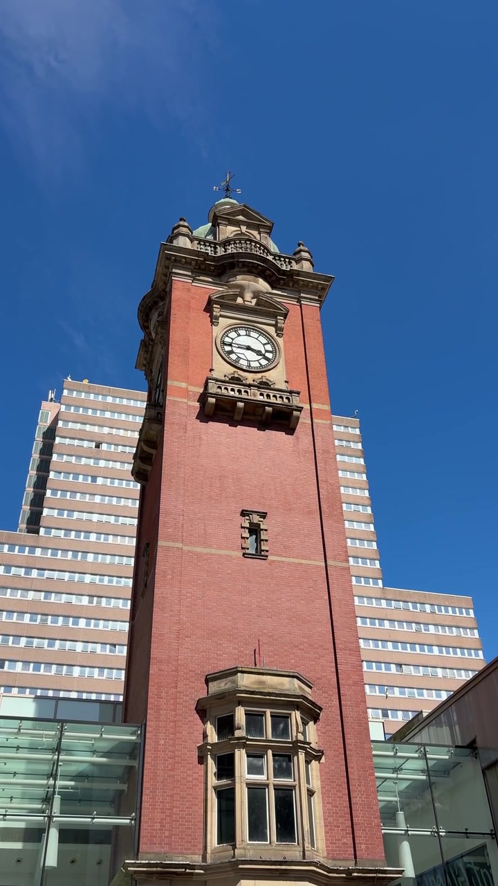 View of the Victoria Centre Clock Tower on Milton Street in Nottingham city centre, featuring a well-known urban landmark and shopping district setting.
