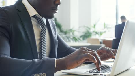 african entrepreneur working on laptop