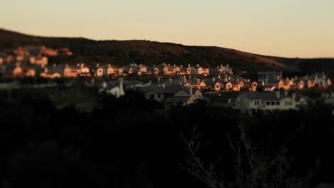 Tract-homes-behind-a-for-sale-in-an-upscale-urban-neighborhood-at-dusk