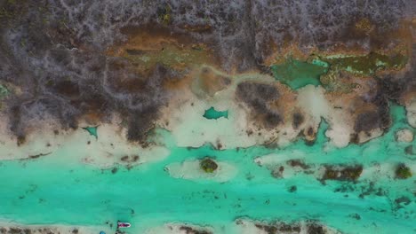 person relaxing in river rapids natural hot spring, bacalar mexico, aerial view