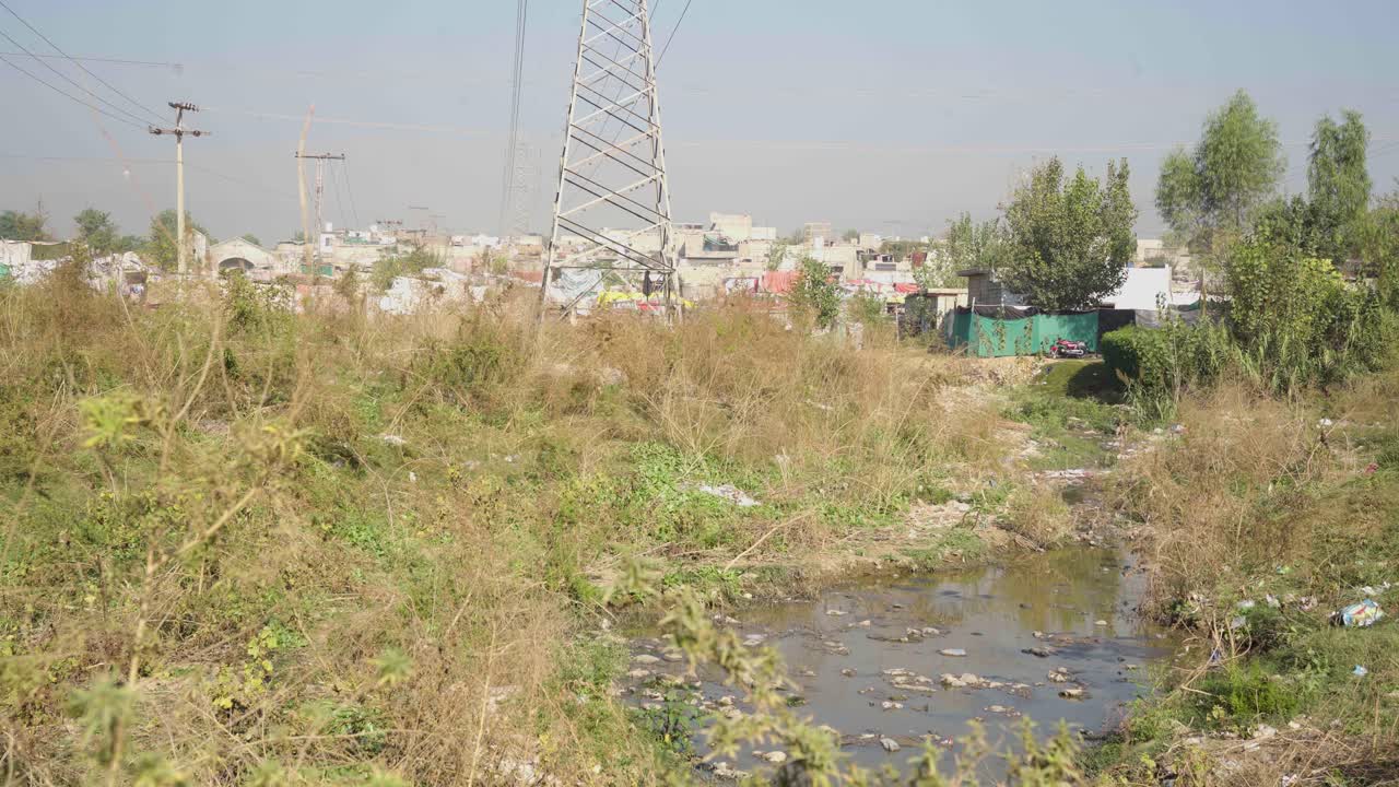 Imagine viewing a quaint town with a clear view of a sewerage tab and towering electric poles scattered throughout. Witness the charm of this unique setting firsthand.