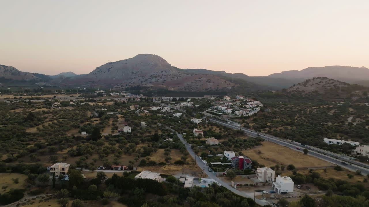 Aerial view following route 95 through a town, sunny evening in Rhodes, Greece