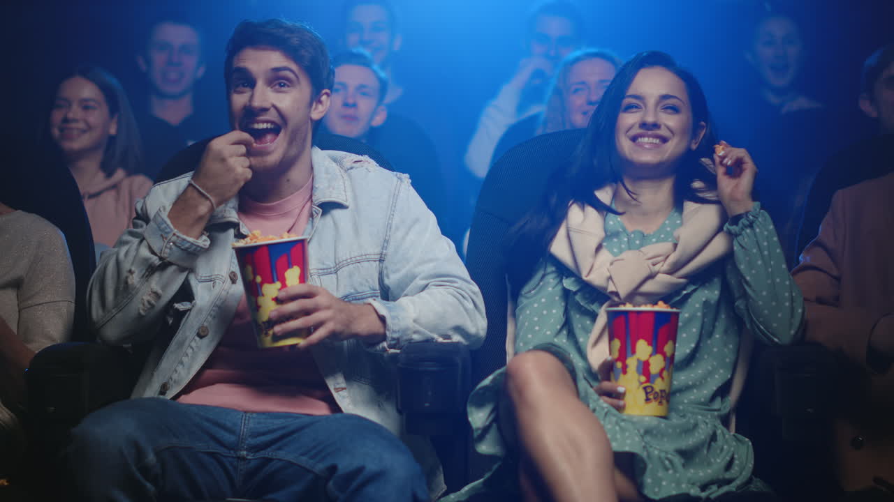 Happy friends having fun in cinema.