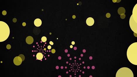 Animation-of-pink-firework-explosions-and-bokeh-yellow-light-spots-on-black-background