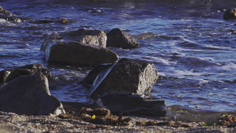 waves splashing against rocks at the beach