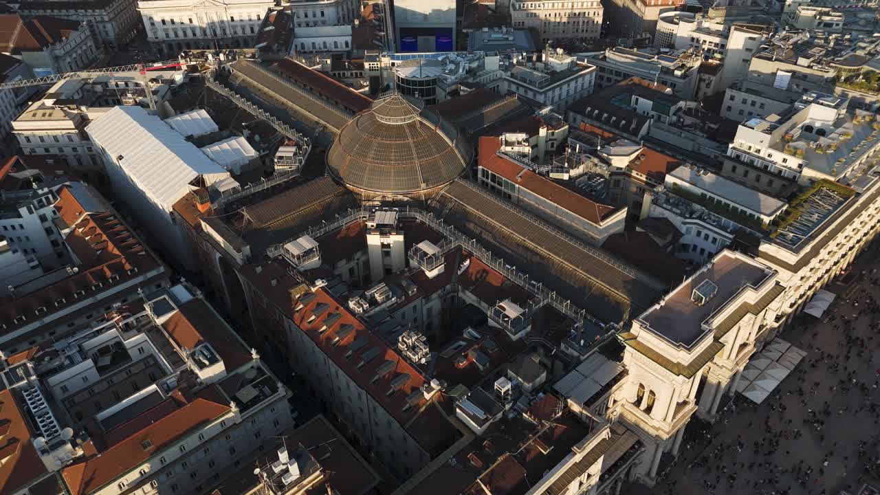 Aerial view at sunset of Milano duomo square cathedral downtown with Vittorio Emanuele gallery , drone top down cityscape